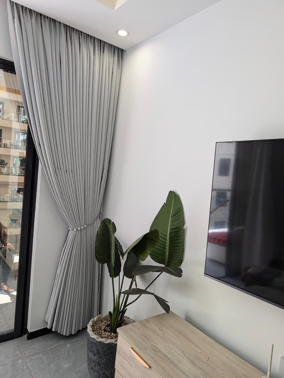 Grey curtains with pearl tieback in a modern living room